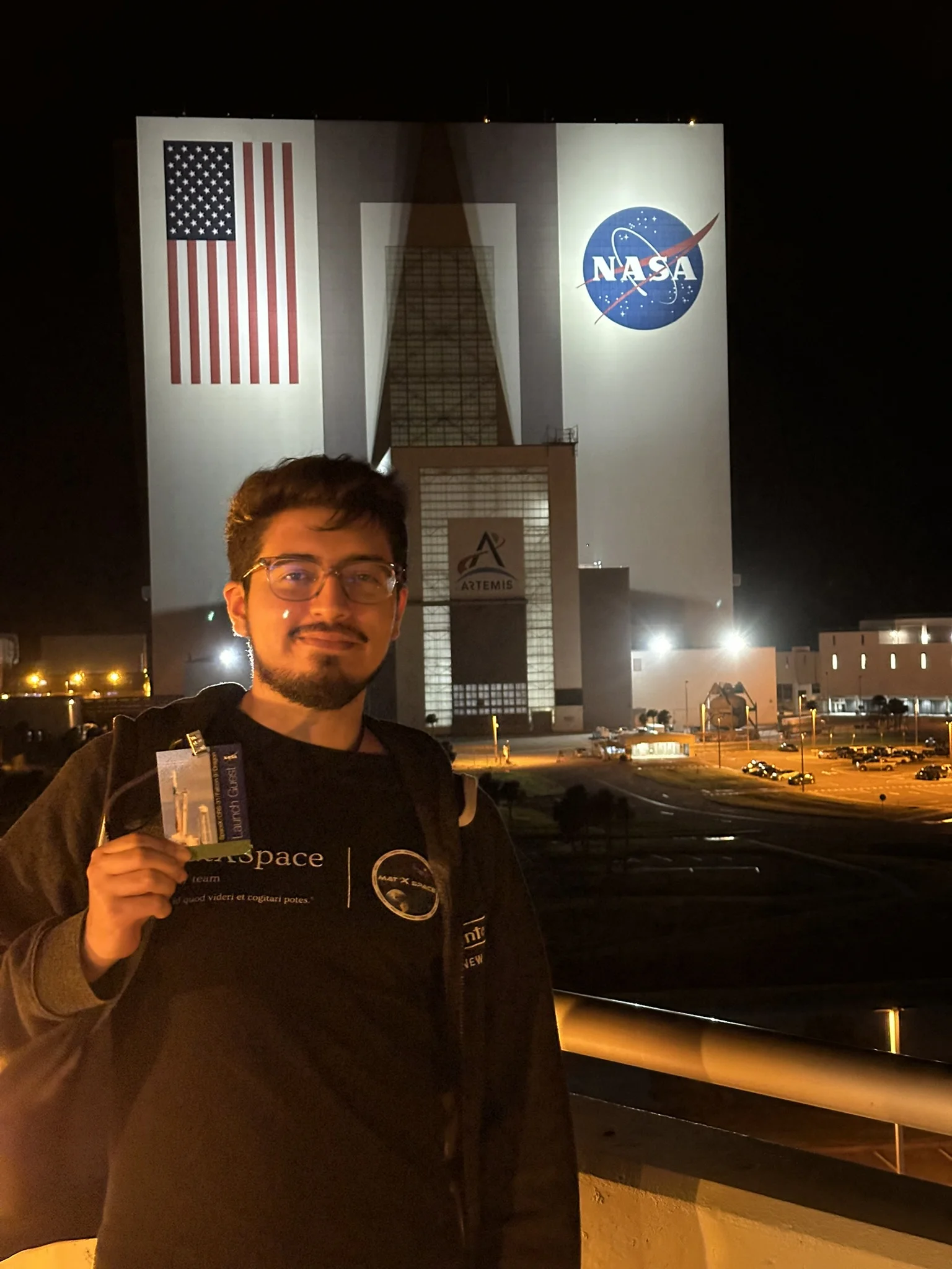 Ivan Galaviz at NASA Kennedy Space Center with the Vehicle Assembly Building and Artemis program branding